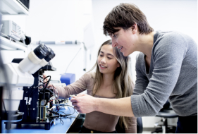 Two researchers building the Remoscope, a malaria diagnostic tool