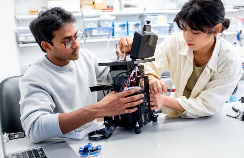 Biohub engineers make final adjustments to a prototype microscope for diagnosing malaria before it’s shipped to Uganda for field tests.