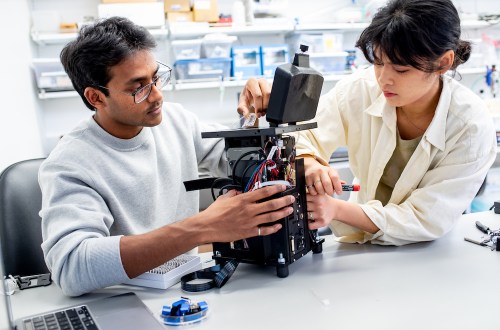 Biohub engineers make final adjustments to a prototype microscope for diagnosing malaria before it’s shipped to Uganda for field tests.