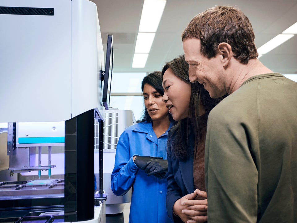 Scientist Angela Detweiler in the genome sequencing laboratory at CZ Biohub San Francisco briefs Mark Zuckerberg and Priscilla Chan