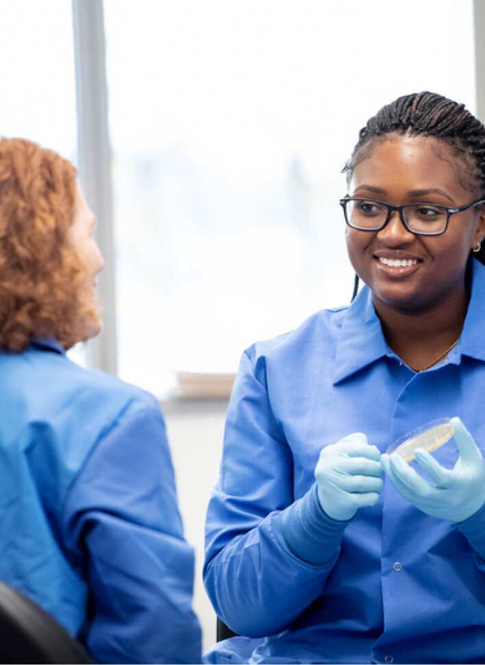 Smiling researcher working at CZ Biohub Network lab