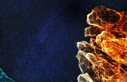 A vividly colorful image of red, orange, yellow, green and blue bursts on a black and blue sky-like background.